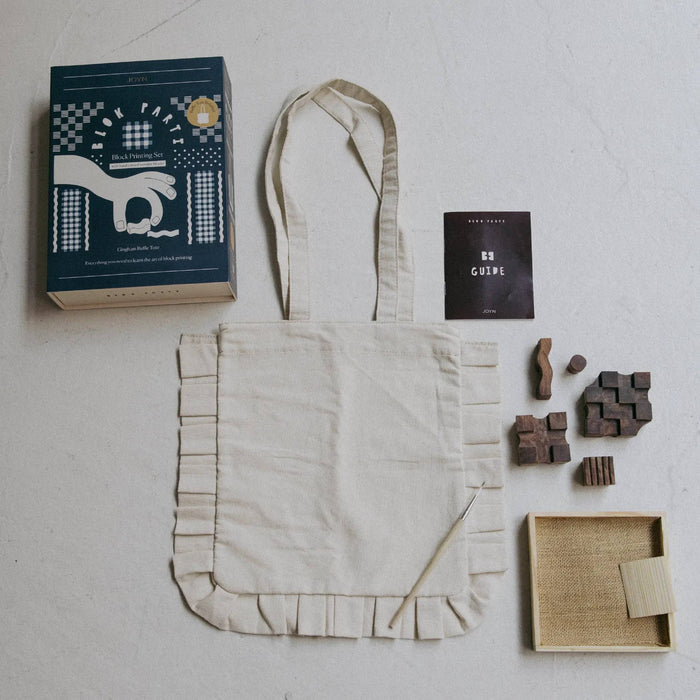 JOYN Blok Parti Gingham Ruffle Tote Block Printing Set contents including a cream ruffle tote, guide, wood blocks, and ink tray.