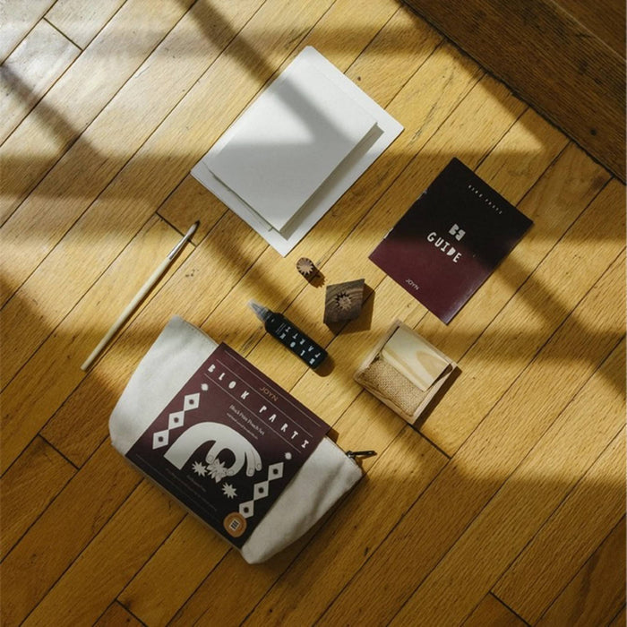 JOYN Blok Parti Harlequin Pouch Block Printing Set contents including a cream canvas pouch, guide book, wood blocks, and ink tray.