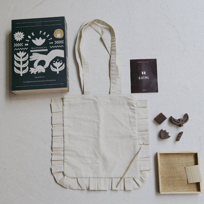 JOYN Blok Parti Tulip Ruffle Tote Block Printing Set contents including a cream ruffle tote, guide, wood blocks, and ink tray.on a plain white background.