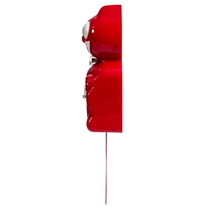 Red cat-shaped wall clock with a long tail and eyes that move, side view on a plain white background.