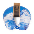 Travel neck pillow with snowy mountain design and a label on a white background.