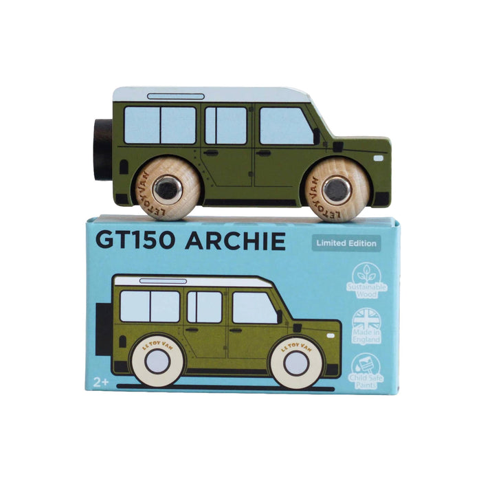 A wooden toy car labeled 'GT150 ARCHIE' in olive green with a white roof, displayed above its light blue retail box on a white background.