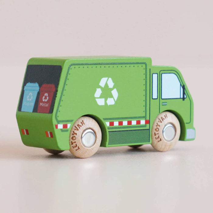 A small wooden toy recycling truck in green with natural wood wheels, back angle view, on a plain light beige background.
