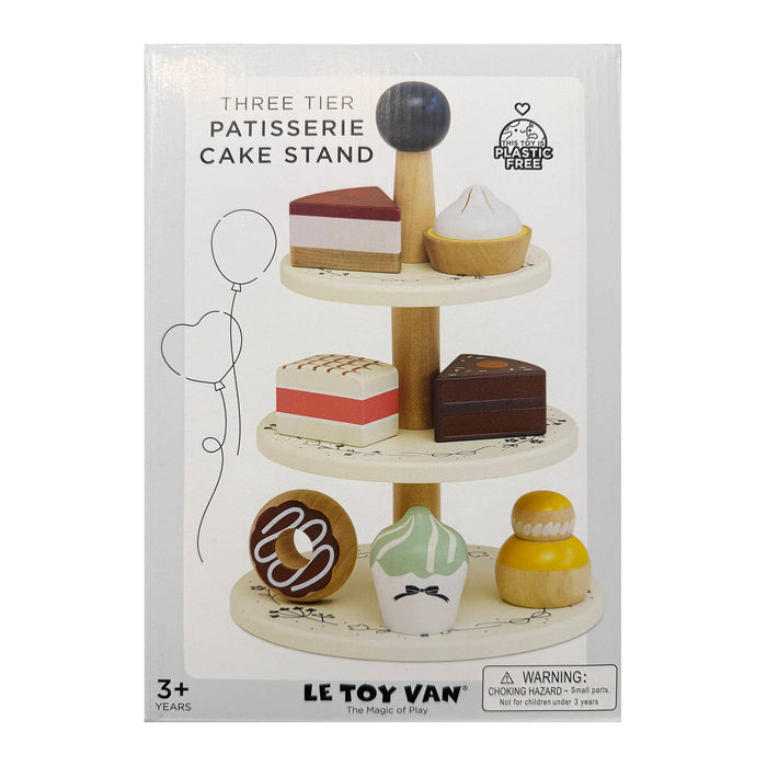 Le Toy Van three-tier patisserie cake stand packaging with toy cakes on a white background.