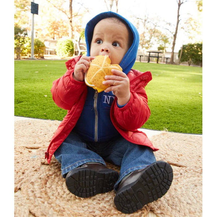 PiccoliNY Lemmegetabaconeggandcheese on a roll natural rubber baby teether in a childs mouth.