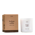 Literie Candles Bodega Coffee scented soy and coconut wax candle in white matte glass vessel beside two-tone brown box, on a white background.