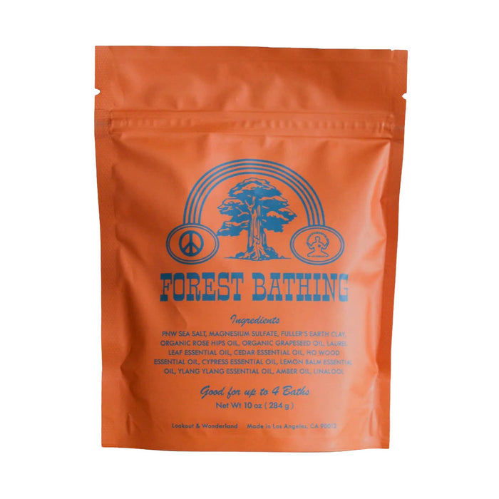 Forest Bathing bath salt soak in an orange resealable stand-up pouch with blue printed graphics and text, photographed on a plain white background.