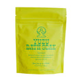 A bright yellow stand-up pouch of Lookout & Wonderland Yuzu Bath Soak with green text and logo, photographed on a plain white background.