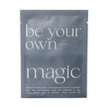 A single flat sheet mask packet in a dark slate blue color with white text reading 'be your own- magic' on a plain white background.