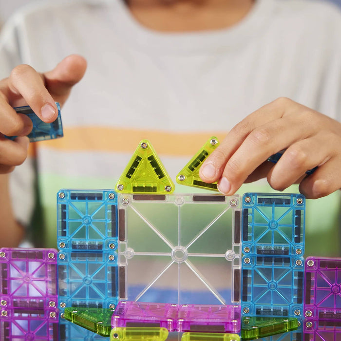 Child playing with colorful magnetic building blocks.