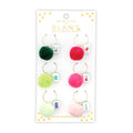 Set of colorful pom-pom and mahjong tile drink charms on a branded card with 'SLANT Collections' logo, on a white background.