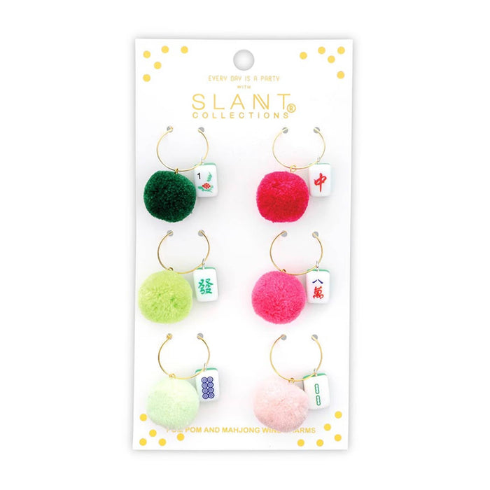 Set of colorful pom-pom and mahjong tile drink charms on a branded card with 'SLANT Collections' logo, on a white background.