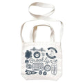 White tote bag with blue Brooklyn graphics and text, with white webbed handles and shoulder strap, on a white background.