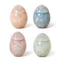 Four marbled glass eggs in different colors on a white background.