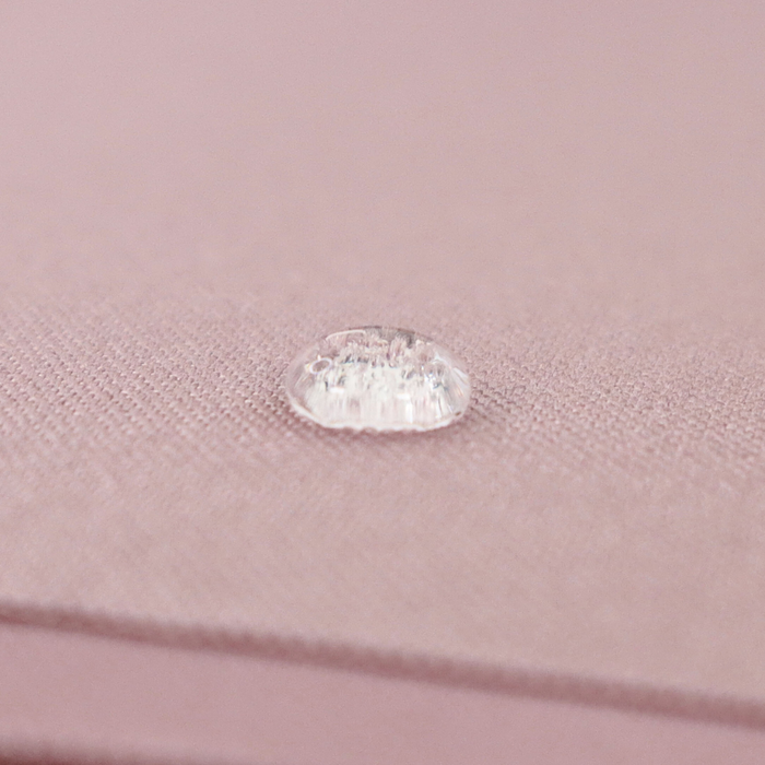 This WPC-Lite solid is a pale purple with pink undertones. This photo shows a water drop on the fabric.
