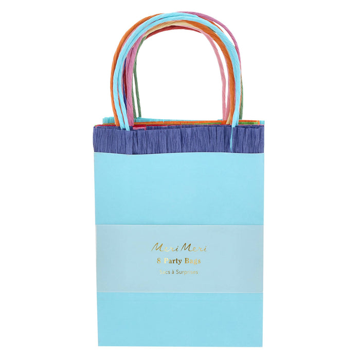 Colorful party bag with rainbow handles in packaging, on a white background.