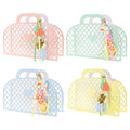 Four colorful mesh paper party favor bags with decorative paper charms, on a white background.