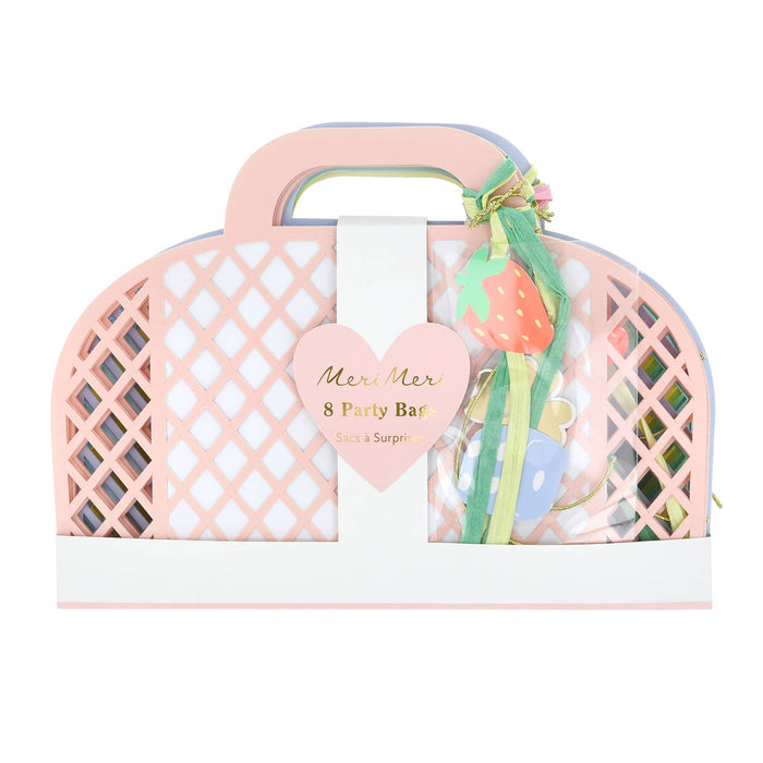 Colorful mesh paper party favor bags with decorative paper charms, in packaging, on a white background.
