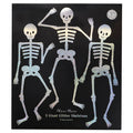 A black square envelope featuring three glittery skeleton decorations with the text 'Meri Meri 3 Giant Glitter Skeletons' on a white background.