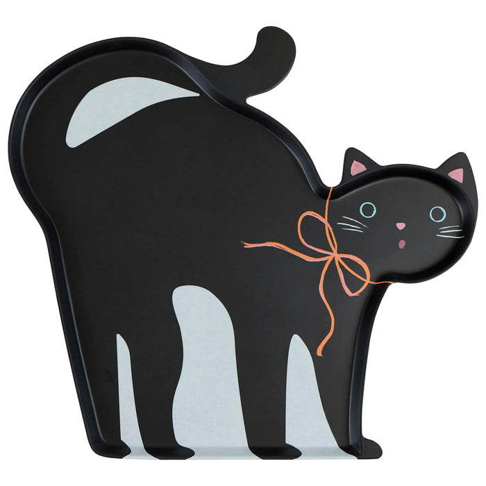 A black cat-shaped melamine serving tray with blue eyes, pink nose and ears, and an orange bow around its neck, front view shown on a plain white background.