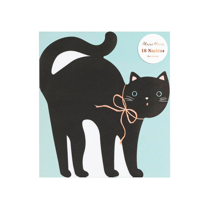 A black cat-shaped die-cut paper party napkin with a peach bow around its neck, blue eyes, and small pink nose and whiskers, shown in packaging on a plain white background.