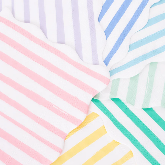 meri meri small napkins with scalloped edges and stripes in red and white, pink and white, yellow and white, lilac and white, blue and white, aqua and white, mint green and white and green and white arranged in a circular fan order