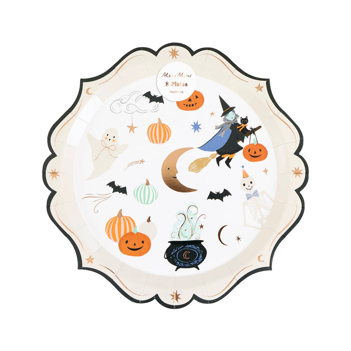 A scalloped paper plate featuring cute Halloween illustrations with a witch riding a broomstick, pumpkins, bats, a ghost, a cauldron, and stars on an off-white background, shown in packaging on a plain white background.