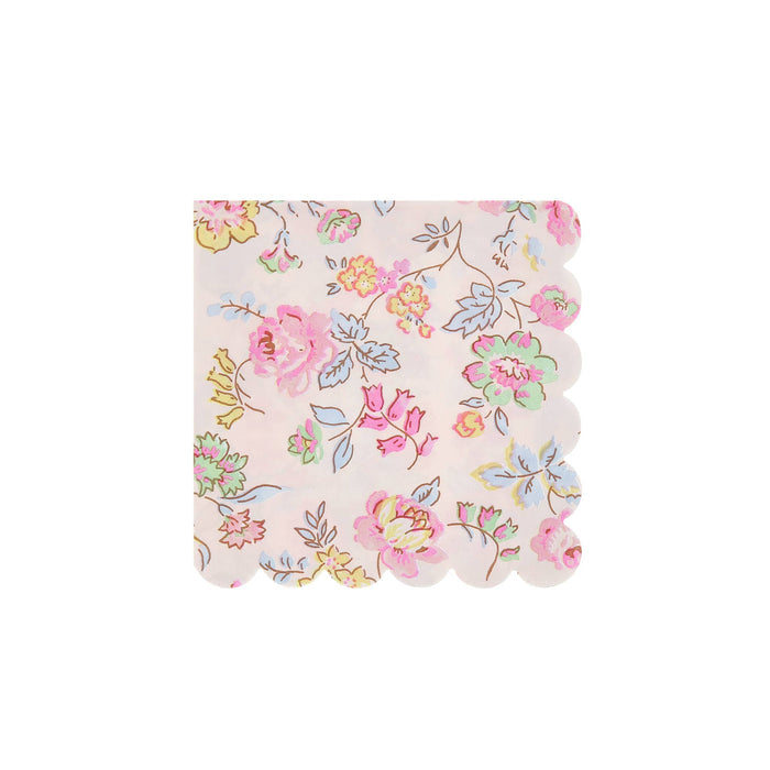 Pink decorative small paper napkin with delicate pastel floral print and scalloped edge, on a white background.