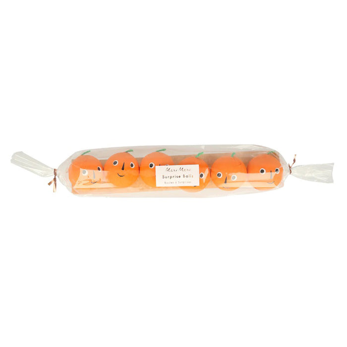 Pack of 6 pumpkin shaped surprise balls with smiley faces and green stems in clear plastic packaging.