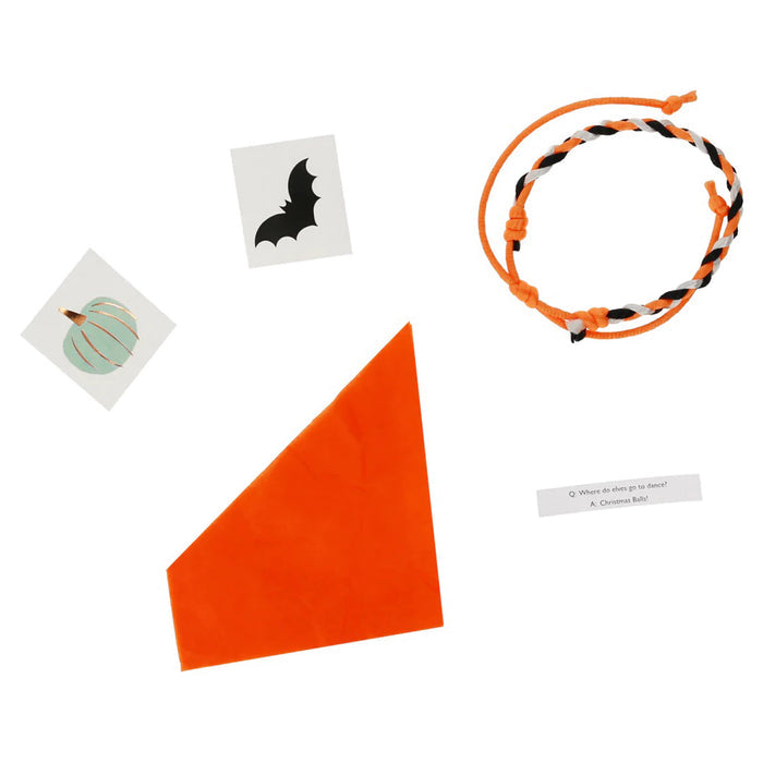 Contents of pumpkin shaped surprise balls include halloween stickers, a friendship bracelet, a paper hat and a joke.