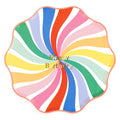 Colorful large paper plate with rainbow swirl design and wavy red edge with 'Happy Birthday' text in gold foil, on a white background.