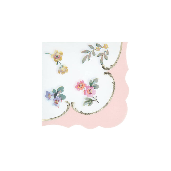 Small paper napkin with pink border, scalloped edge and floral illustrations, on a white background.