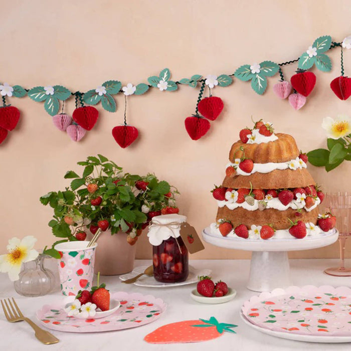 Meri Meri Strawberry Pattern large paper party dinner plates with scalloped edge in party setting.