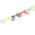 Colorful velvet bow garland on a white background.