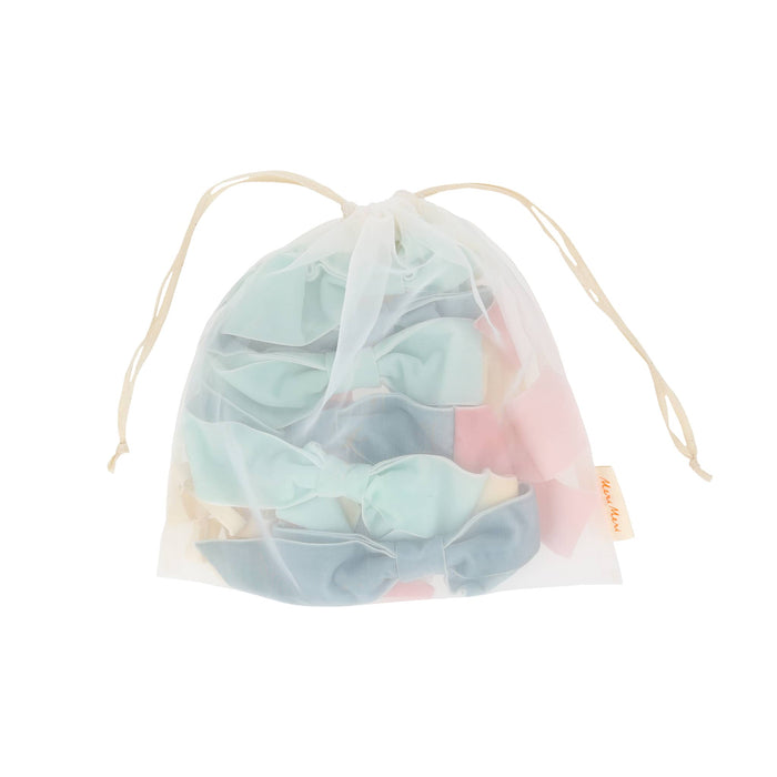 Drawstring organza bag with pastel-colored velvet bows, on a white background.