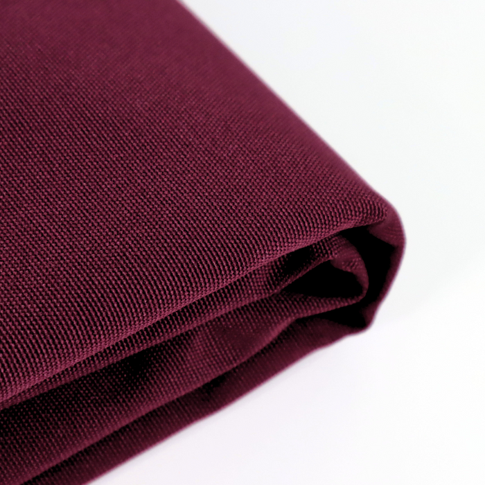 This ReNew Canvas solid is a deep shade of red with purple undertone. This photo if of the fabric folded.