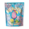 Front of the Pink Flamingo frozen cocktail mix in pouch packaging with pink and blue tropical design elements, on a white background.