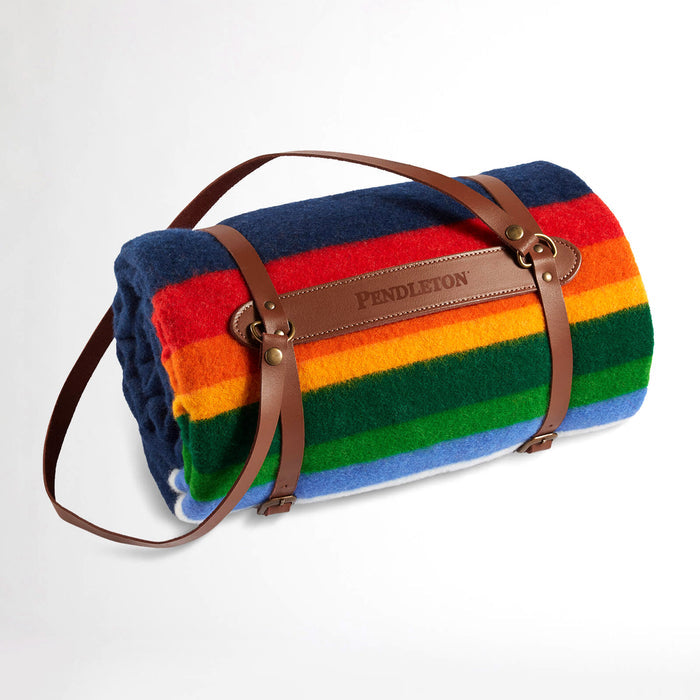 Pendleton Crater Lake National Park Throw Blanket in navy, rolled up in leather carrier.
