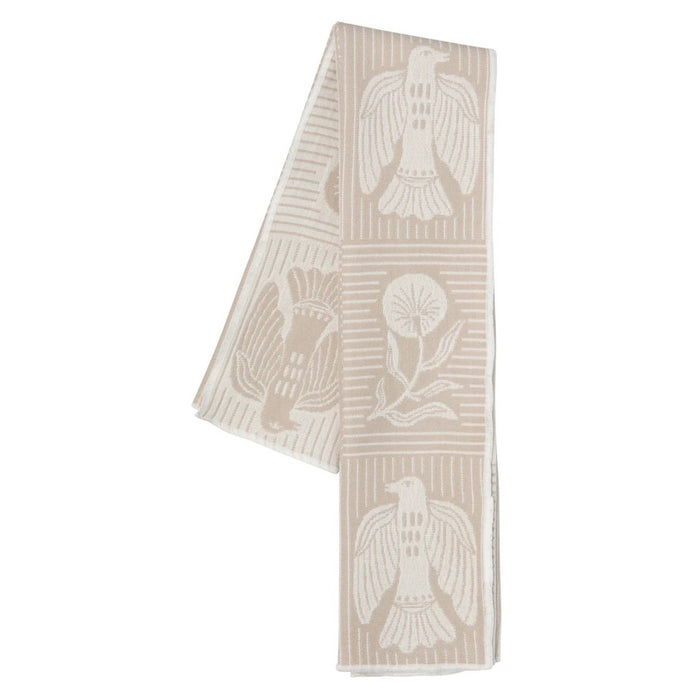 Beige towel with white bird and floral patterns, folded, on a white background.