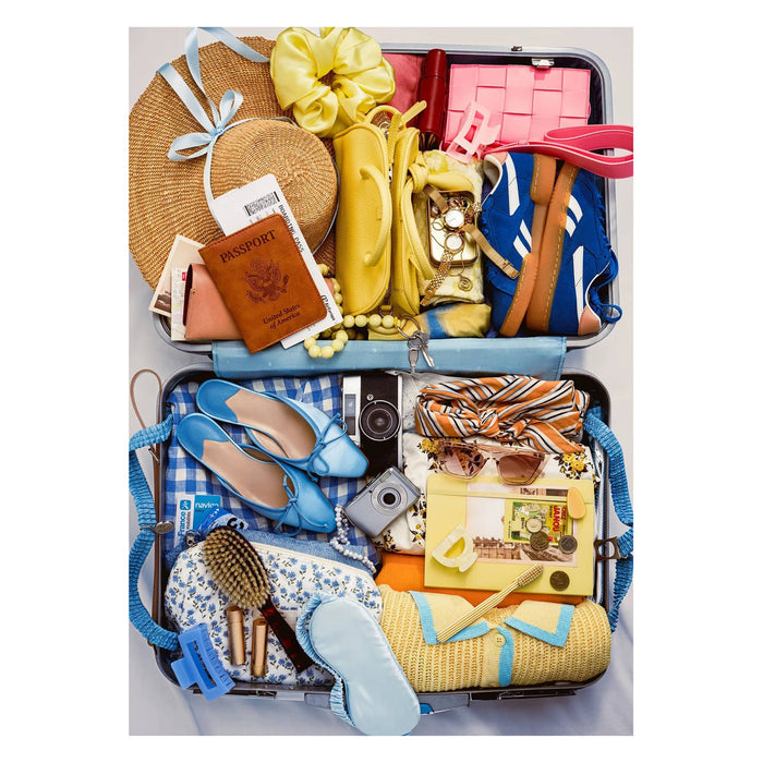 1000 piece Bon Voyage puzzle, original photo of a packed vintage suitcase, on a white background.