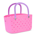 Pink perforated basket with purple handles, front angle view, on a white background.