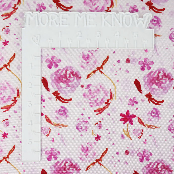 This printed WPC-Lite is of watercolor flowers in warm pink tones. This photo shows a white L shaped ruler for scale.