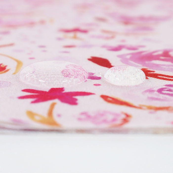 This printed WPC-Lite is of watercolor flowers in warm pink tones. This photo shows water droplets on the fabric.