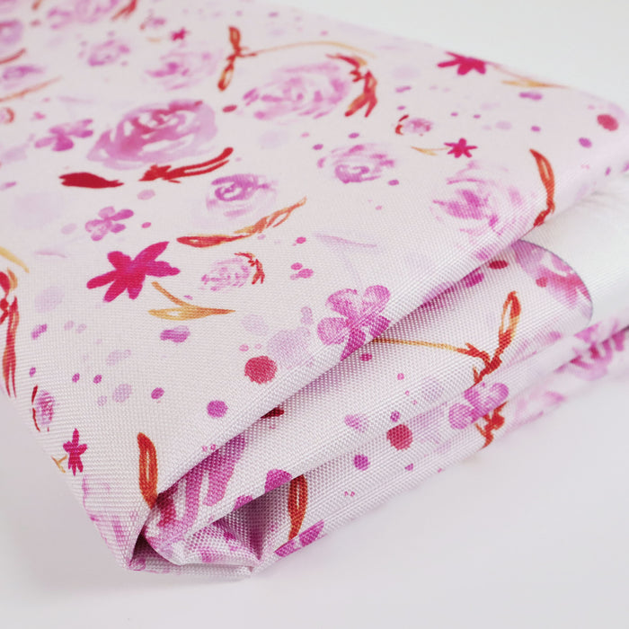 This printed WPC-Lite is of watercolor flowers in warm pink tones. This photo is of the fabric folded.
