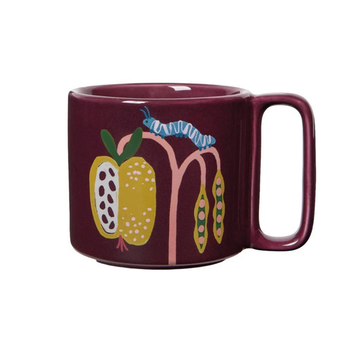 A dark burgundy ceramic mug featuring a whimsical illustration of yellow guava fruits, pink stems, and a blue-and-white caterpillar on the side, set against a plain white background.