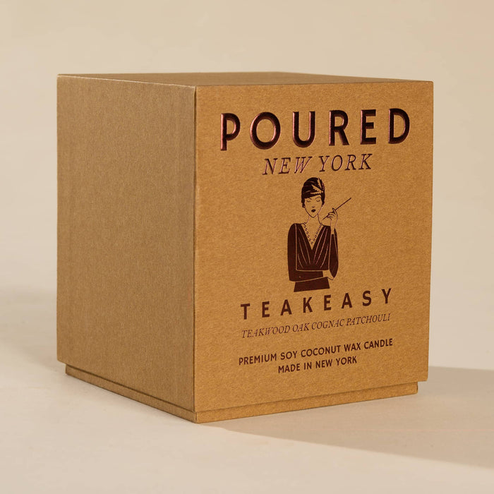 A square kraft paper box for a Poured New York Teakeasy candle, featuring a dark brown foil graphic of a woman holding a cigarette holder and product text, set against a warm beige background.