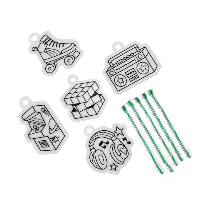 Set of 5 black and white shrink art charms with green bead chain on a white background.