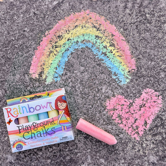 Box of Rainbow Playground Chalks with a pink chalk and rainbow and heart drawings on pavement.