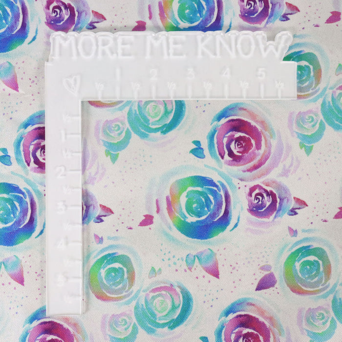 This printed WPC-Lite is of watercolor roses in a rainbow ombre. This photo shows a white L shaped ruler for scale.