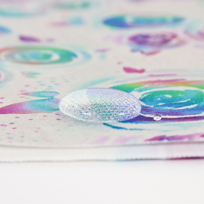 This printed WPC-Lite is of watercolor roses in a rainbow ombre. This photo shows a water drop on the fabric.